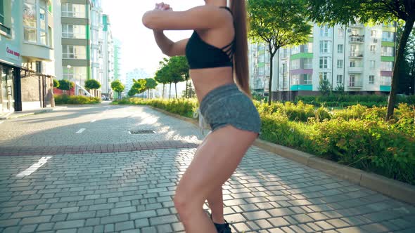 Young Woman Squatting in Outdoors in Morning