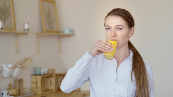 Beautiful Girl Drinking Fresh Orange Juice From Glass. Close Up Happy Woman Drinking Fruit Beverage