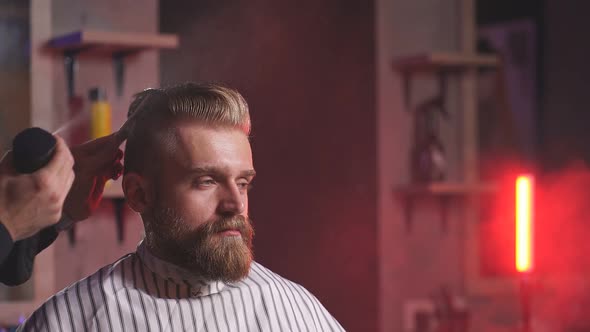 Hairdresser Makes Hairstyle for a Stylish Man