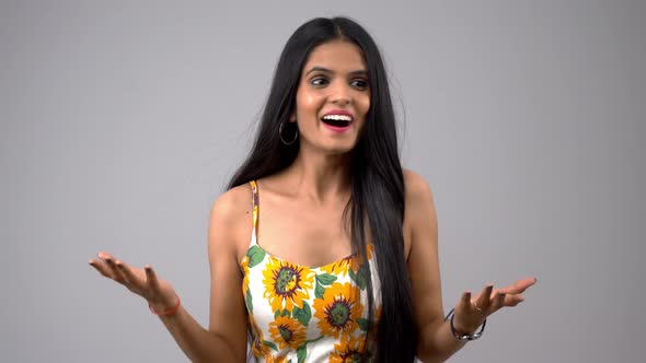 Happy and excited Indian girl acting surprised