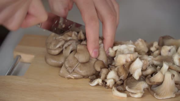 Closeup of King Oyster Mushrooms on a Wooden Cutting Board