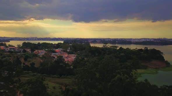 Beautiful aerial view flying backwards over the Sao Paulo favelas at sunset