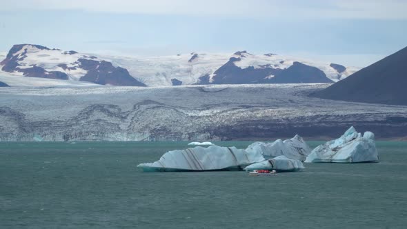 A Boat Floating Among Icebergs