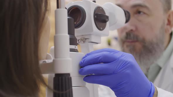 Optometrist Using Slit Lamp during Eye Exam