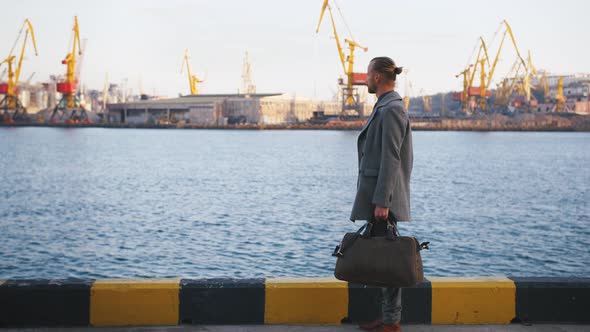 Young Stylish Redhead Handsome Hipster Man on Sea Port Background During Sunset