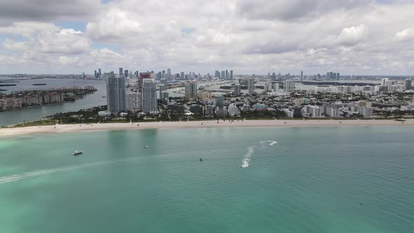 Aerial wide angle video of Miami Beach with overcast sky clouds