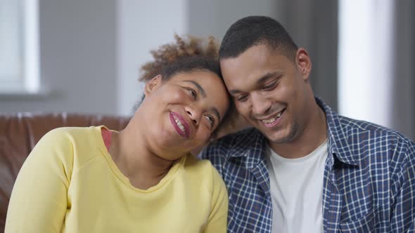 Happy African American Couple Hugging Looking at Camera Smiling