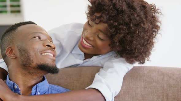 Woman embracing man in living room