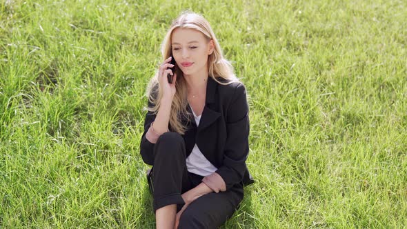 Smiling Woman Sitting on Grass