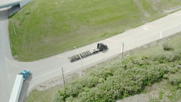 Aerial Drone View of Truck Rides on Road That Turns