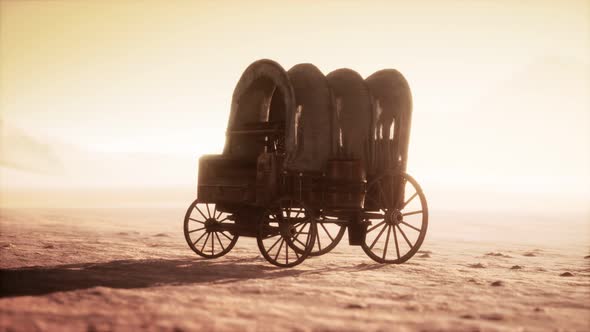 Canvas Covered Retro Wagon in Desert at Sunset