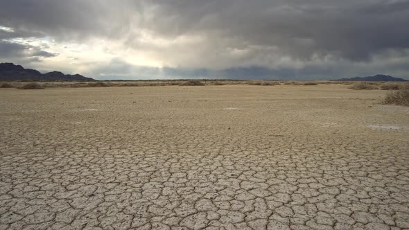 Panning over dry cracked earth in the desert Salt Flats in Utah