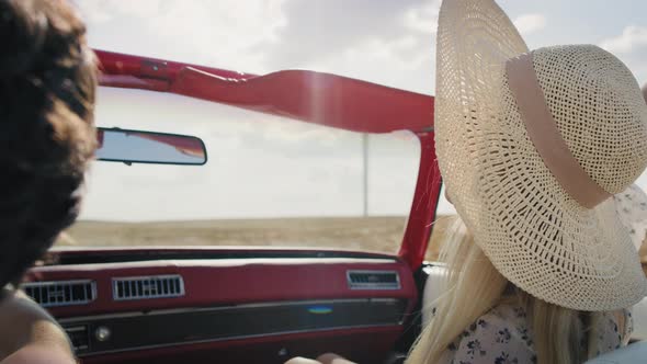 Rear view video of happy couple driving a car. Shot with RED helium camera in 8K