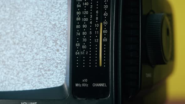 Small Old Television with Grey Interference Screen on Yellow Background