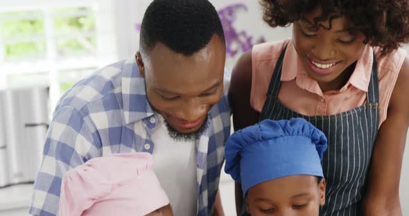 Happy family preparing food in kitchen