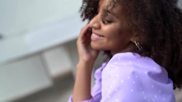 Happy and Joyful Black Woman with Charming Curly Hair Is Smiling and Dancing