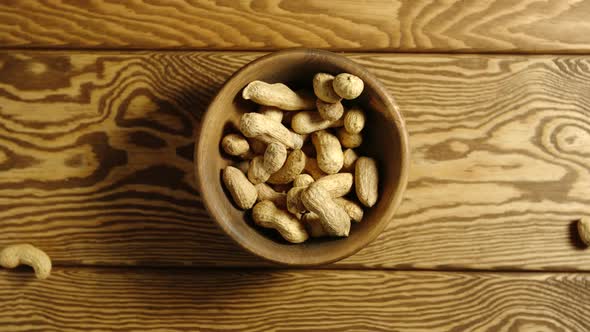 Peanuts Fall Into Wooden Cup