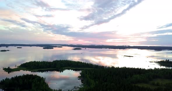 Colorful Sunset lighting up the archipelago with vibrant sky reflected like a mirror in the calm sea