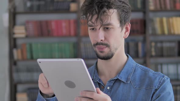 Sad Casual Young Man in Awe for Losing Online on Tablet