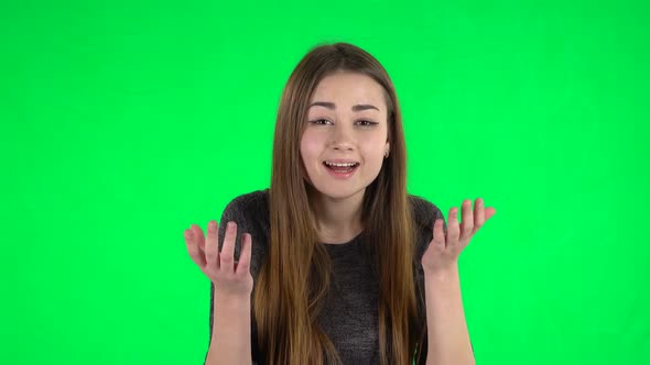 Portrait of Cute Brunette with Long Hair with Shocked Wow Face Expression on a Green Screen