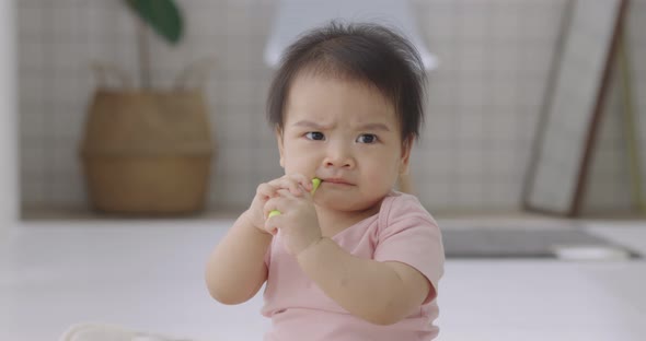 Adorable Asian Baby Practice To Using Toothbrush For Clean Her Oral For Good Oral Health.