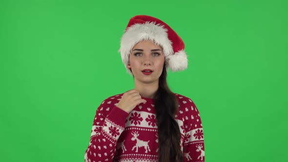 Portrait of Girl in Santa Claus Hat Is Cooling Herself By Her Hand, Suffering From High Temperature