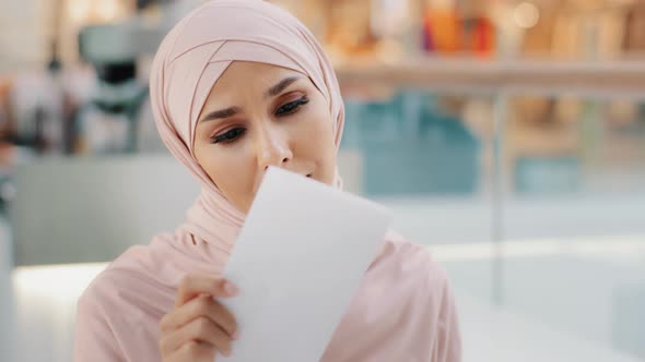 Closeup Young Muslim Woman in Hijab Opens Paper Letter Reads Bad News Shocked Feels Disappointed Sad