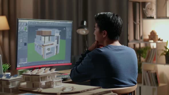 Asian Male Engineer Thinking While Designing House On A Desktop At Home