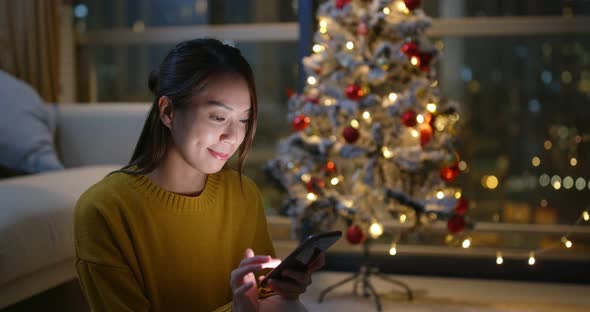 Woman use of mobile phone at Christmas time