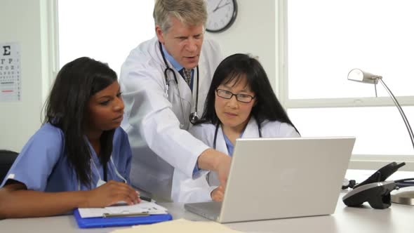 Medical people looking at laptop computer