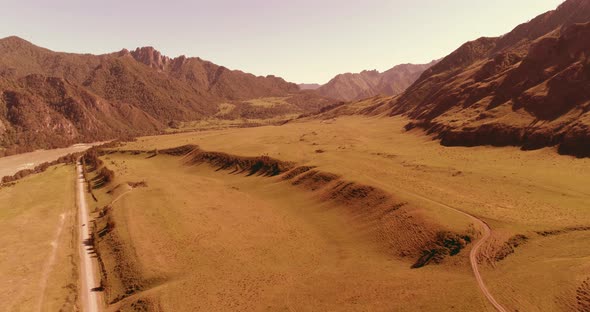 Aerial Rural Mountain Road and Meadow at Sunny Summer Morning