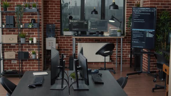 Computer Screens on Desk in Empty Software It Agency Office and Computers in Background