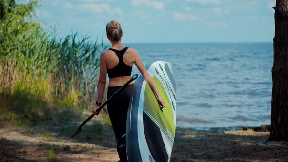 Woman Carries Sup Board On Vacation. Tourist Floating Standup Paddle Board. Swim Surfing Boat.