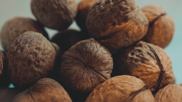 There is a Small Pile of Walnuts Resembling a Brain the Shell of the Nuts is an Even Brown Tint