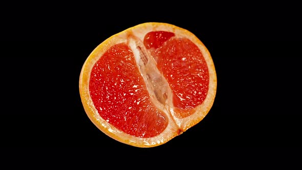 Red Grapefruit Cut in Two on a Black Background