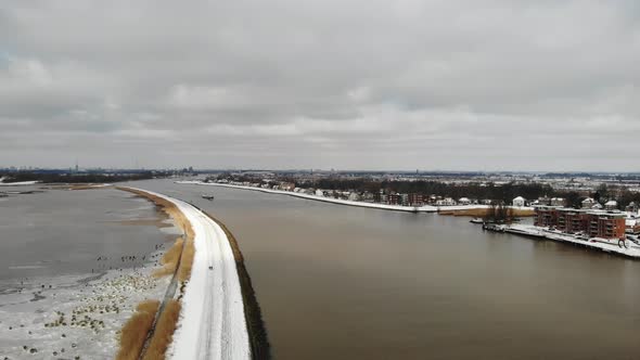 Frosted Crezeepolder And River Noord With Cargo Ship Sailing Near Ridderkerk In Netherlands. - Stati