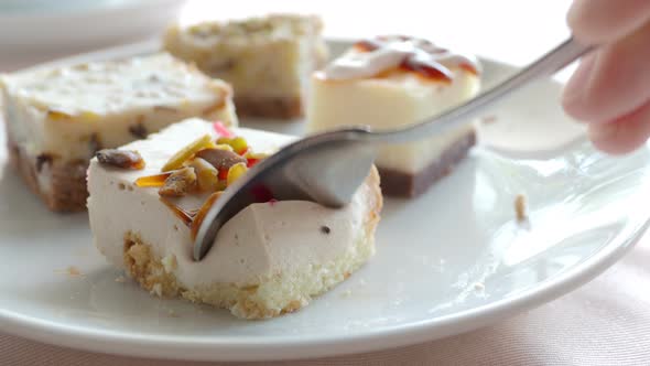 White Plate Full of Different Pastries. Tasty Desserts with Topping, Coconut Flakes. Somebody