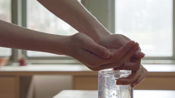 Corona pandemic - kids hands using hand sanitizer to prevent coronavirus spread