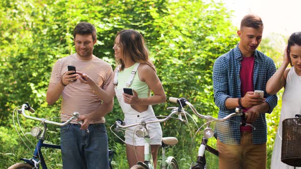 Friends with Bicycles and Smartphones at Park 