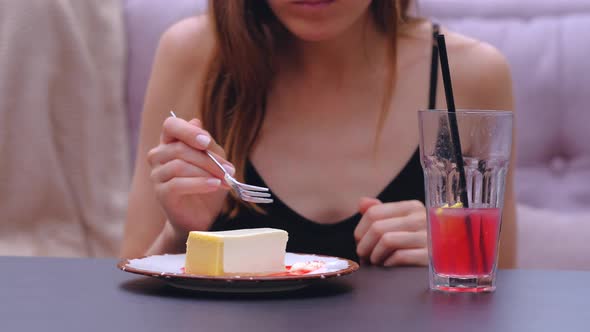 Unrecognizable Woman Eat Cheesecake in Cafe