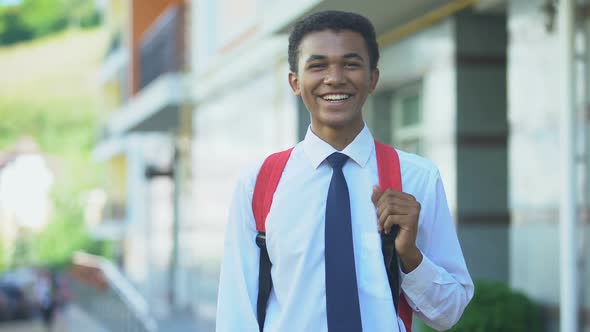 Smiling African-American Male Student With Backpack Posing on Camera, Education
