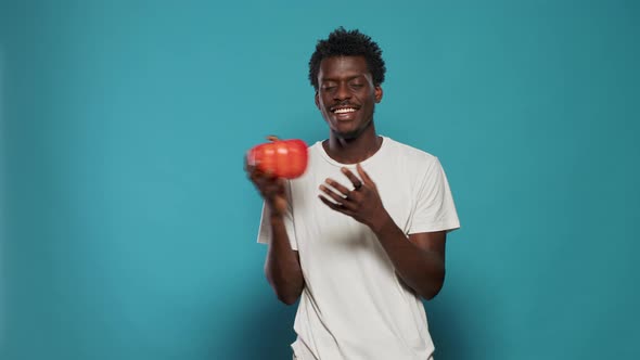 Vegan Person Holding Red Bell Pepper in Hand to Cook