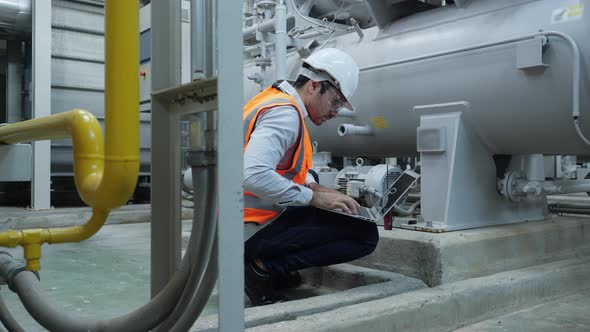 Industrial engineer using laptop inspect