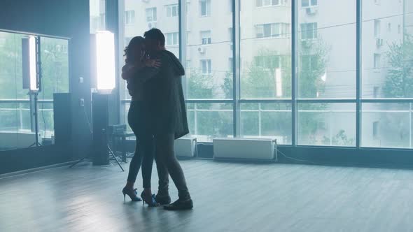 A Beautiful Couple Performing Kizomba Dance Elements in a Dance Studio