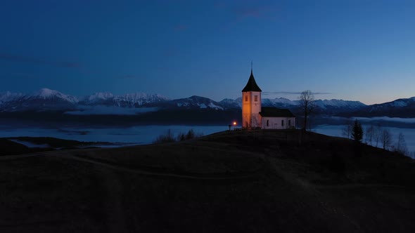 Church of St. Primoz and Felicijan in the Morning. Jamnik, Slovenia. Aerial View