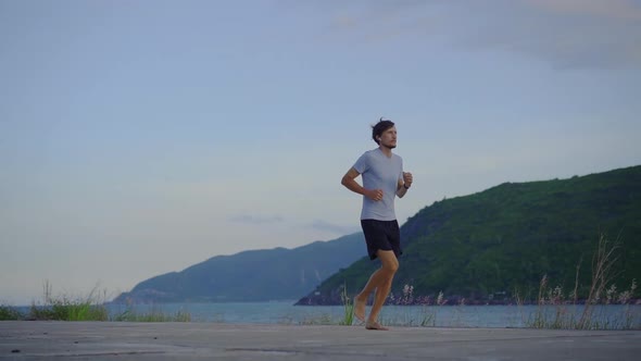 Slow Motion Shot of a Young Man Running Barefoot