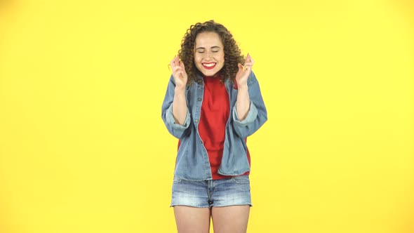 Curly Girl Looking at the Camera with Excitement, Then Celebrating Her Triumph with Victory Dances