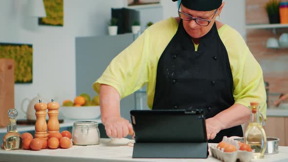 Woman Chef Using Tablet in Kitchen