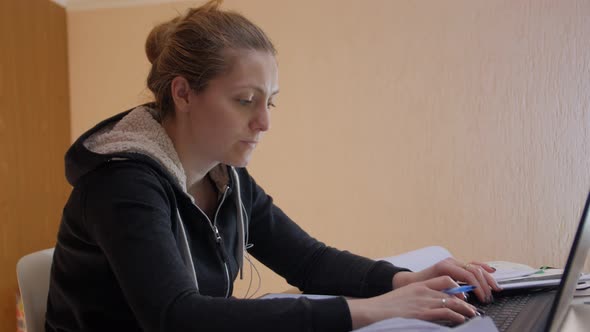 Woman Is Counting Finances On Laptop