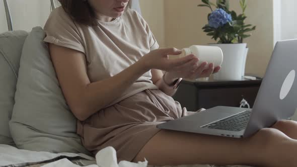 Woman Drinks Pills and Consults Online with a Doctor
